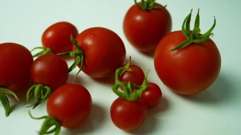 Ripe Red Tomatoes with Green Stems, A collection of ripe red tomatoes with .. Stock Footage 304978628
