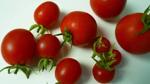 Ripe Red Tomatoes with Green Stems, A collection of ripe red tomatoes with .. 動画素材 304978762