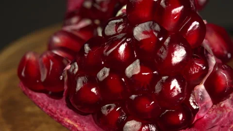 Ripe ruby pomegranate close up rotates. Fresh juicy pomegranates seeds or garnet 스톡 동영상 307803312