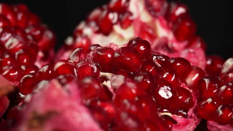 Ripe ruby pomegranate rotates on black background close up. Fresh juicy Stock Footage 307803673