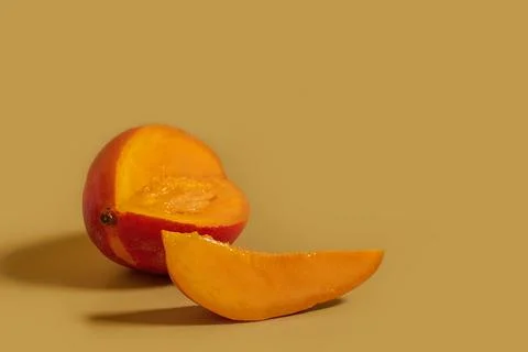 Ripe sliced mango and a slice on a colored background Stock Photos