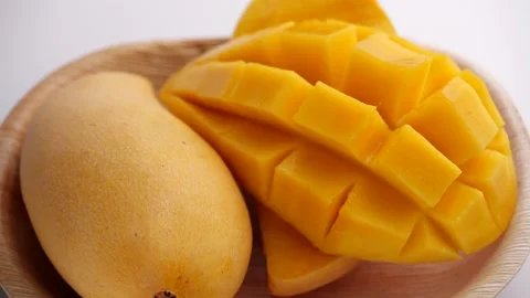 Ripe Slide of mangoes. Sliced Mango Squared rotation in 4k slow motion Stock Footage 131691053