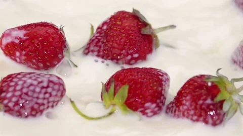 Ripe Strawberries Falling into the Milk. Stock Footage 76996947