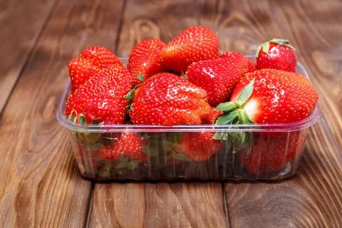Ripe strawberries in a plastic container Stock Photos