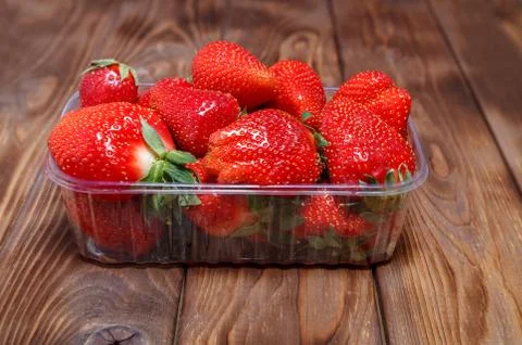 Ripe strawberries in a plastic container Stock Photos
