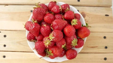 Ripe strawberries in a plate on the table Stock Footage 131548868