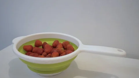 Ripe strawberries on the table in a colander. 4K Stock Footage 111669320