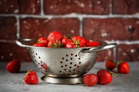 Ripe strawberry in colander Stock Photos