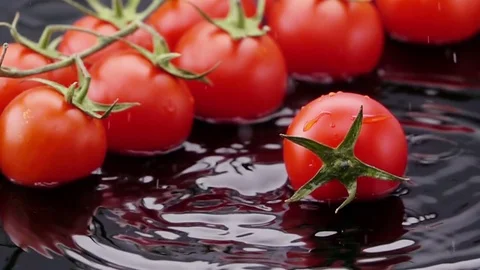 Ripe Tomato Falls on the Table. Stock Footage 72841156