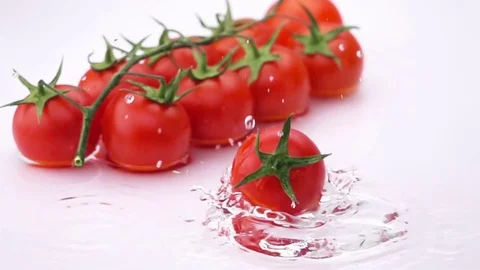 Ripe Tomato Falls on the Table. Stock Footage 76728429