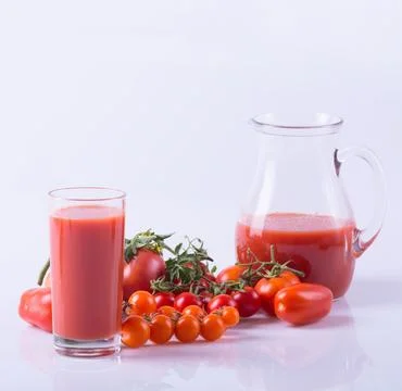 Ripe tomatoes of different sizes and juice . Food background Stock Photos