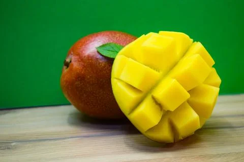 Ripe Tropical Mango Fruit on Wall Background with Natural Light Stock Photos