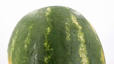 Ripe watermelon rotating, (loopable) on white background. Shot in 4K Stock Footage 114116773