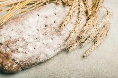 Ripe wheat with bread on grey rustic background 스톡 사진
