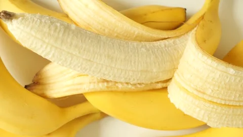 Ripe yellow bananas dolly shot on a white background Stock Footage 334829853