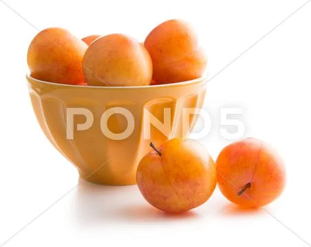 Ripe yellow plums in bowl. Stock Photos