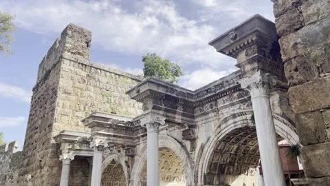 Riple-arched Hadrian's Gate built in 130 AD with marble columns under a sunny Stock Footage 342206043