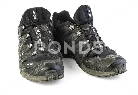 Ripped and dirty Salomon trail running shoes Stock Photos