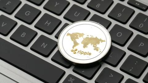 Ripple Coin Cryptocurrency on a Computer Keyboard Panning Stock Footage 87770741