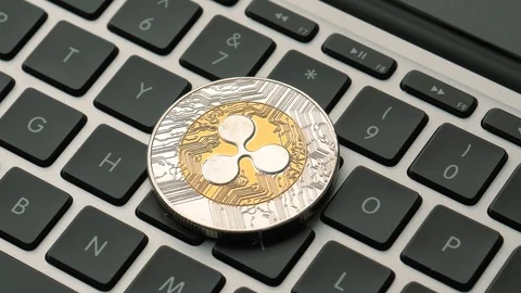 Ripple Coin Cryptocurrency on a Laptop Computer Keyboard Panning Stock Footage 87770789