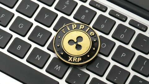 Ripple Cryptocurrency Coin on a Computer Keyboard Panning Stock Footage 87771301