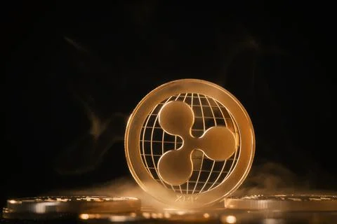 Ripple cryptocurrency coin stack on dark background with smoke Foto stock