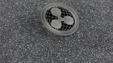 Ripple cryptocurrency falls on silver sequins. Stock Footage 155544135
