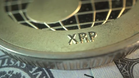 Ripple. Cryptocurrency. Macro shot of popular gold cryptocoin lies on USD Stock Footage 143377172