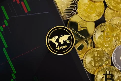 Ripple on digital tablet with graph by various coins Stock Photos