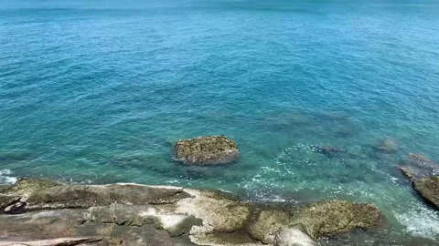 Ripple water attack to Rough reef rock and clear water sea and blue color Stock Footage 193986014