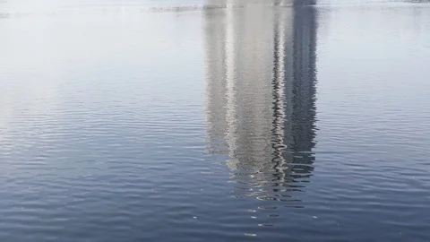 Ripple Wave Water Reflection Alone Building and Blue Sky Stock Footage 128679512