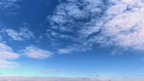 Rippled altocumulus clouds drift over a blue sky in time lapse, atmospheric Stock Footage 340332627