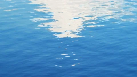Rippled blue ocean wave reflects sky with clouds Stock Footage 152649082