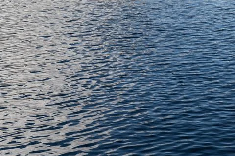 Rippled blue water surface background, full frame shot of blue water covere.. Stock Photos