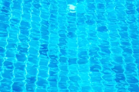 Rippled pattern of blue water in a swimming pool Stock Photos