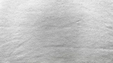 Rippled sand texture with subtle waves soft shadows tiny dark speck in minima Stock Photos