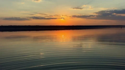 Rippled Water Surface Reflecting Golden Sunset Stock Footage 341755955