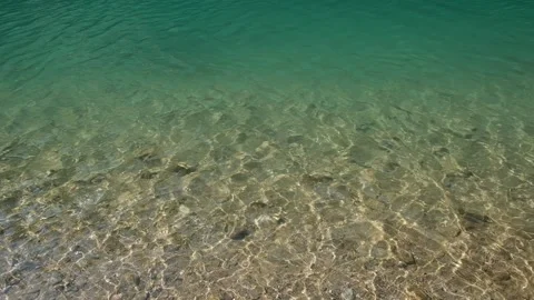Ripples of clear gradient water in the river, rocky bottom under the water. Sun Stock Footage 158130543