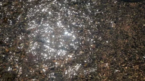 Ripples of clear river water and rocky Stock Footage 297631340