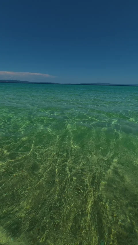 Ripples glide across the surface. Trani Ammouda, Greece. Vertical Stock Footage 339630144