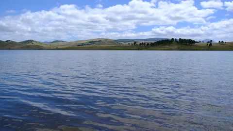 Ripples in Lake, Rolling Hills in Background, Low Angle, 4K Stock Footage 142556733