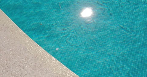 Ripples on the surface of a swimming pool in bright sunlight Stock Footage 325885899