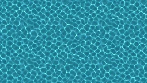 Ripples on the surface of a swimming pool or tropical sea from above Stock Footage 306114266