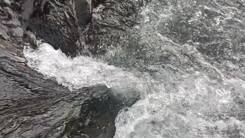 Ripples of water flowing between the rocks 스톡 동영상 237016639