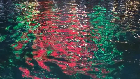 Ripples on the water with reflections in the evening, glare from colorful lights Stock Footage 317719034
