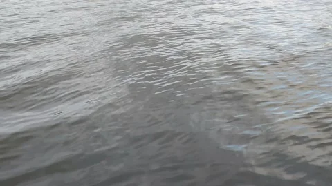 Ripples of water on the river. The calm surface of real water on the lake Stockbeeldmateriaal 176410609