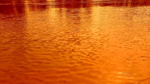 Ripples on the water, the wind. Dynamic video substrate. Orange colors Video stock 107090960
