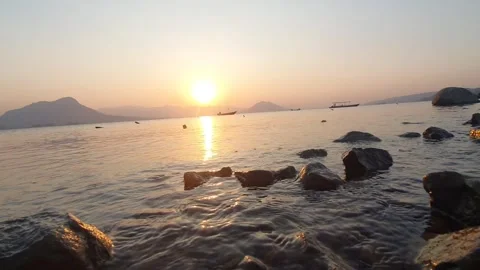 Ripples of waves on the shore of the lake with a view of the sunset Stock Footage 254362445