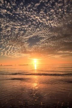 Ripples of waves under a sunset sky of red and orange at South Marco Island B Stock Photos