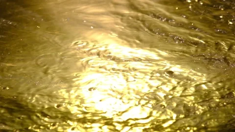 Rippling bight gold water-like background Stock Footage